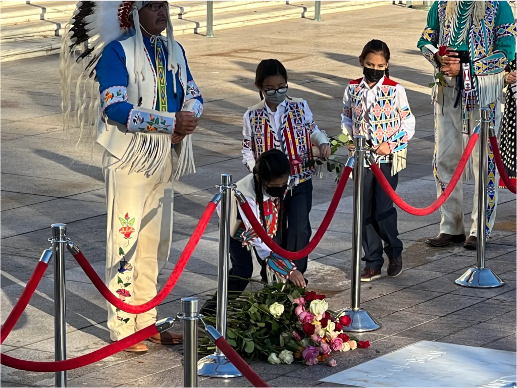 Crow Nation citizens and representatives, including students from Plenty Coups High School, are the first to lay down flowers at the Tomb of the Unknown Soldier Centennial Commemoration in Arlington, Virginia, on November 9, 2021. (Photo by Jourdan Bennett-Begaye, Indian Country Today)