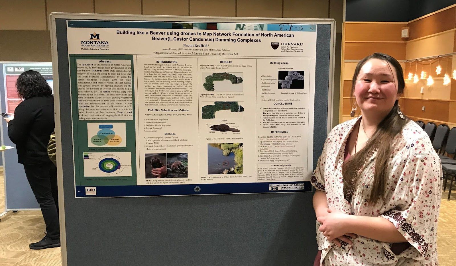 Naomi Redfield stands with her research poster at the 2019 McNair Research Symposium. Redfield wants to pursue a master’s in microbiology and study reproduction, nutrition and changes in the gut microbiome in animals and eventually pursue a career in the veterinary field.