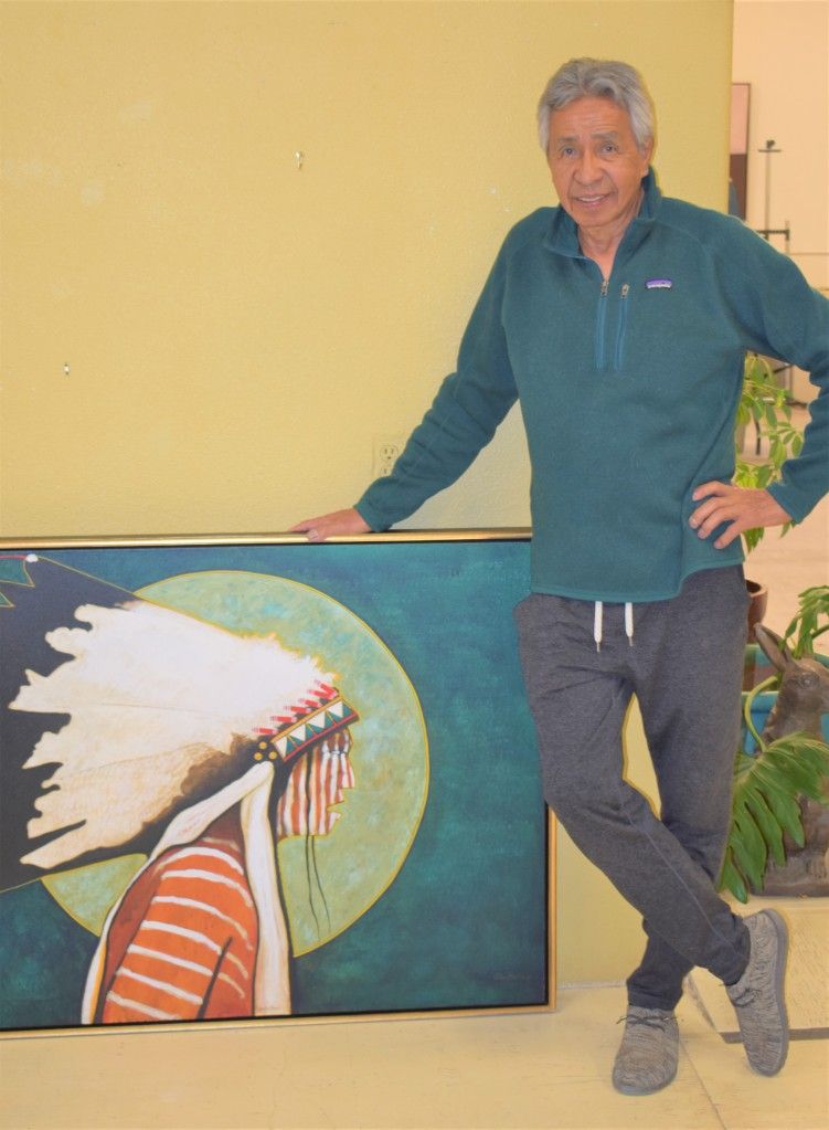 Redstar poses with original artwork at his gallery in Roberts, Montana. / Courtesy Photo