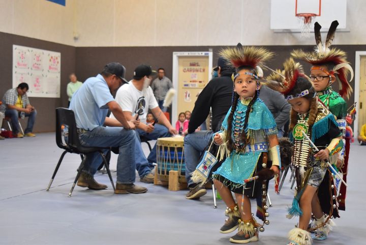 Little hot dancers circle the drum at the Crow Agency Public School Powwow. The powwow was on hold for a few years during the