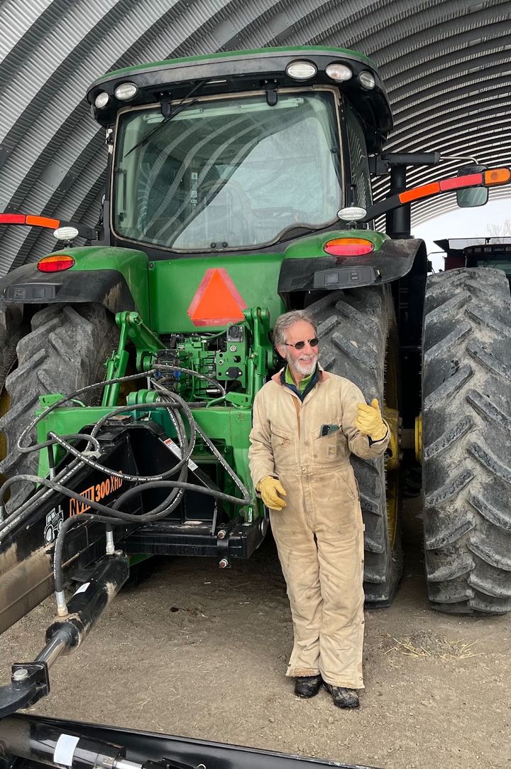 Tom Kay poses in  February 2023 in front of his John Deere tractor. / Photo by Dave Marston